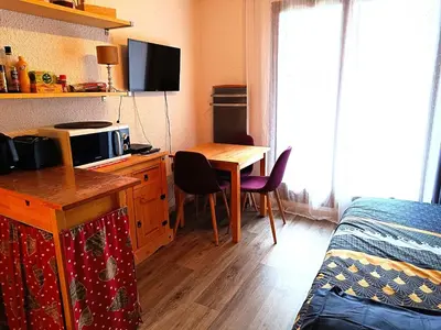 a room with a bed and a desk with a table at Les Hauts De Saint Gervais in Saint-Gervais-les-Bains