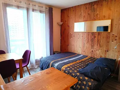 a hotel room with a bed and a table and a window at Les Hauts De Saint Gervais in Saint-Gervais-les-Bains