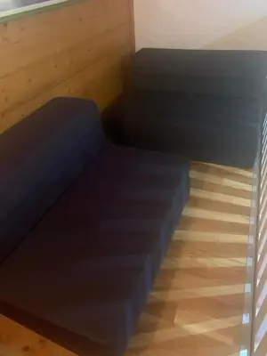 a bed in a room with a wooden floor at LES TOURISTES in Combloux