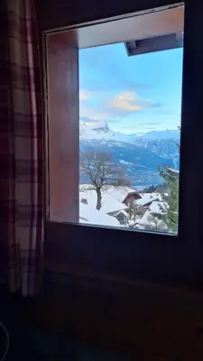 a window with a view of a snow covered mountain at LES TOURISTES in Combloux