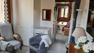 a living room with a chair and a table at LES TOURISTES in Combloux