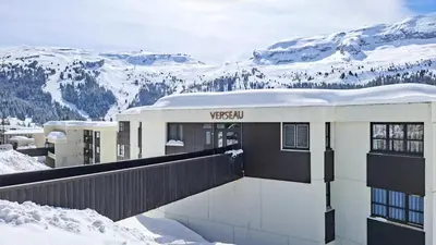 a building on top of a snow covered mountain at Résidence Verseau - Appartement lumineux et spacieux · Centre station · avec cabine et Balcon MAE-8894 in Magland