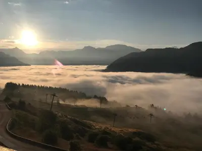 a view of a foggy valley with the sun in the background at Arve et Giffre Samoens 1600 in Samoëns