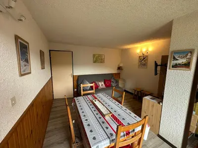 a living room with a table and a couch at Arve et Giffre Samoens 1600 in Samoëns