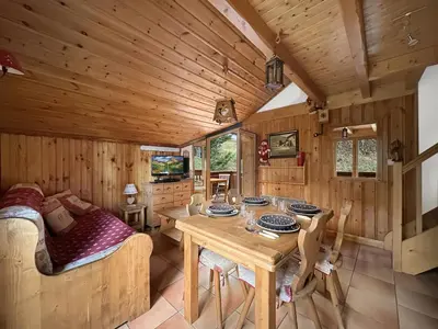 a dining room with a table in a cabin at luta11 duplex mezzanine 2 4 pers pied de pistes in Les Carroz d'Araches