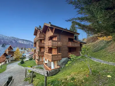 a wooden house on top of a hill at luta11 duplex mezzanine 2 4 pers pied de pistes in Les Carroz d'Araches