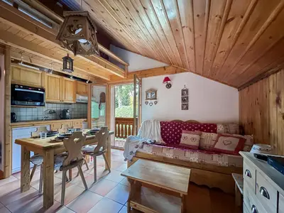 a living room with a red couch and a table at luta11 duplex mezzanine 2 4 pers pied de pistes in Les Carroz d'Araches