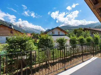 a staircase in a house with a concrete wall at Chalet convivial à proximité des pistes avec balcon et WIFI - FR-1-663-23 in Saint-Gervais-les-Bains