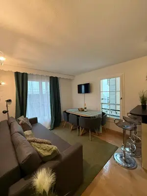 a living room with a couch and a table at Be first on the lift each morning! 2bed apt. 6 pax in Saint-Gervais-les-Bains