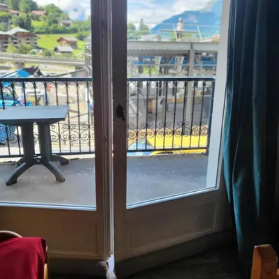 a door to a balcony with a table and a view at Be first on the lift each morning! 2bed apt. 6 pax in Saint-Gervais-les-Bains