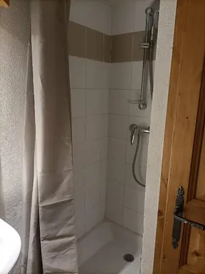 a shower with a shower curtain in a bathroom at Be first on the lift each morning! 2bed apt. 6 pax in Saint-Gervais-les-Bains