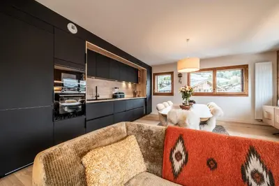a living room with a couch and a table at Apartment Centaurea Megève - BY EMERALD STAY in Megève