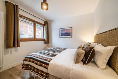 a bedroom with a bed and a window at Apartment Centaurea Megève - BY EMERALD STAY in Megève