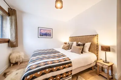 a bedroom with a bed and a dog in it at Apartment Centaurea Megève - BY EMERALD STAY in Megève