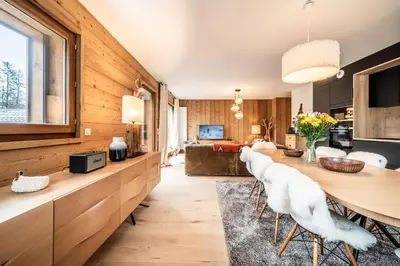 a kitchen and dining room with a table and chairs at Apartment Centaurea Megève - BY EMERALD STAY in Megève