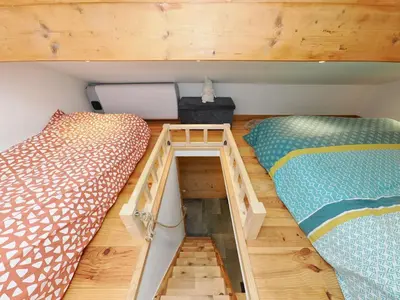 two bunk beds in a room with wooden floors at Le Nid Cosy in Passy