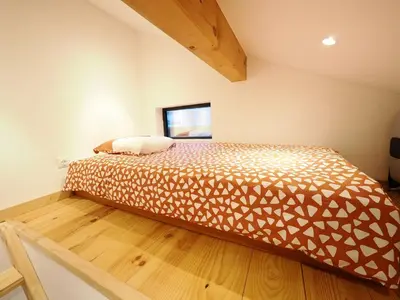 a bedroom with a bed in a room at Le Nid Cosy in Passy
