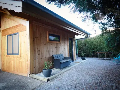 a house with a chair sitting outside of it at Le Nid Cosy in Passy