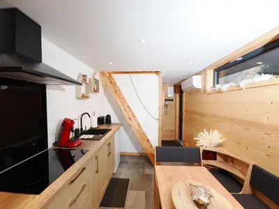a kitchen with a large window in a tiny house at Le Nid Cosy in Passy