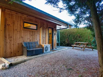 a house with a couch and a tv on the side of it at Le Nid Cosy in Passy