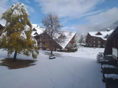 a snow covered yard in front of a lodge at Studio 4 couchages 