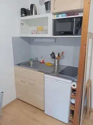 a small kitchen with a sink and a microwave at Studio 4 couchages 