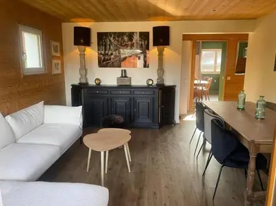 a living room with a couch and a table at Appartement Au pied du Jaillet in Megève