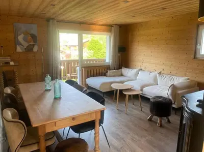 a living room with a couch and a table at Appartement Au pied du Jaillet in Megève