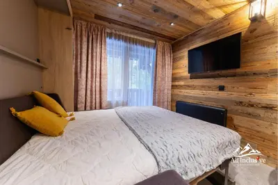 a bedroom with a bed and a flat screen tv at 