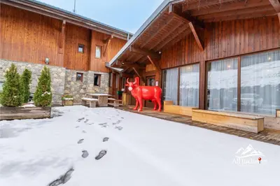a red cow statue in front of a building at 