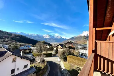 a view of the mountains from the balcony of a house at Le Doux Sapin in Saint-Gervais-les-Bains