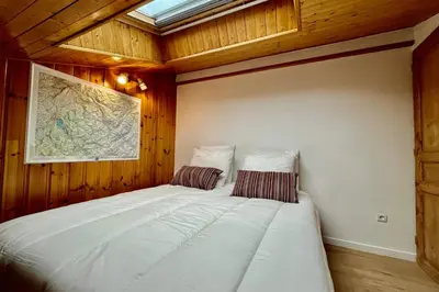 a bedroom with a large white bed in a room at Le Doux Sapin in Saint-Gervais-les-Bains