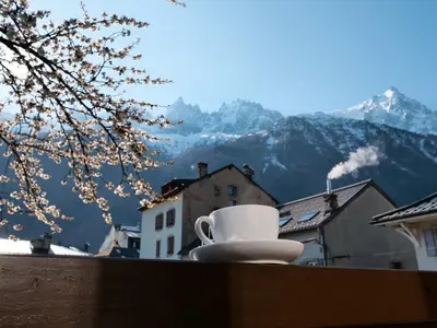a dining room with tables and chairs and wine glasses at Chalet hôtel le Whymper in Chamonix-Mont-Blanc