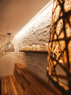 a room with a wall with candles and a window at Chalet hôtel le Whymper in Chamonix-Mont-Blanc
