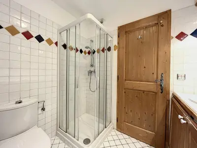 a bathroom with a shower with a glass door at Chamonix: Appartement 3 pièces, 6 pers, Parking - FR-1-507-76 in Chamonix-Mont-Blanc