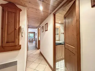 a hallway leading to a kitchen with wooden ceilings at Chamonix: Appartement 3 pièces, 6 pers, Parking - FR-1-507-76 in Chamonix-Mont-Blanc