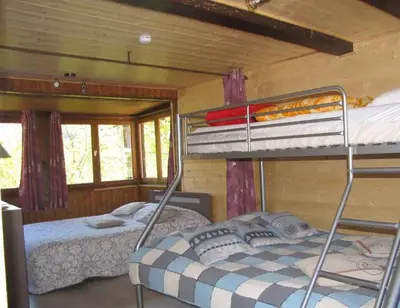 a bedroom with two bunk beds in a cabin at Sublime maison 15 personnes in Saint-Gervais-les-Bains