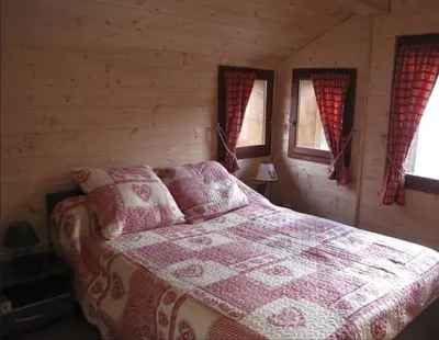 a bedroom with a bed in a log cabin at Sublime maison 15 personnes in Saint-Gervais-les-Bains