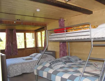 a bedroom with two bunk beds in a cabin at Sublime maison 15 personnes in Saint-Gervais-les-Bains