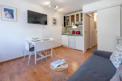 a living room with a couch and a table at Cosy studio with view of Brévent in Chamonix-Mont-Blanc
