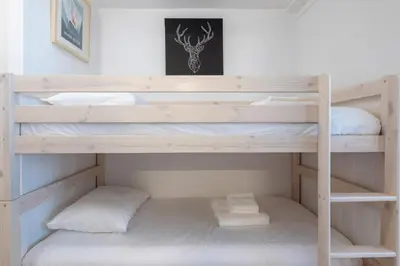 a bunk bed with two pillows on the bottom bunk at Cosy studio with view of Brévent in Chamonix-Mont-Blanc
