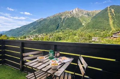 two people rafting down a river with a snow covered mountain at Cosy studio with view of Brévent in Chamonix-Mont-Blanc