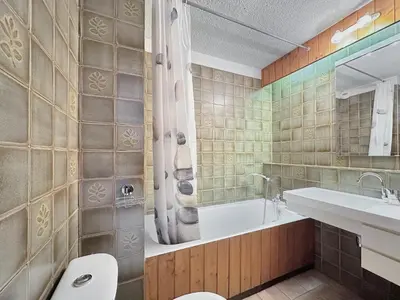 a bathroom with a tub and a toilet and a sink at MOU2E Studio 4 Pers centre des Carroz in Les Carroz d'Araches