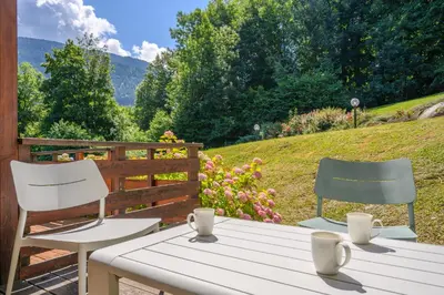 a table and two chairs sitting on a patio at Le Cocon Des Pistes in Saint-Gervais-les-Bains