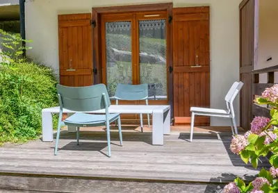 two chairs and a table on a patio at Le Cocon Des Pistes in Saint-Gervais-les-Bains
