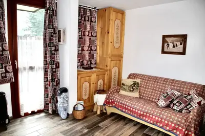a living room with a couch and a window at Chez moi in Chamonix-Mont-Blanc