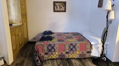 a bedroom with a bed with a suitcase on it at Chez moi in Chamonix-Mont-Blanc