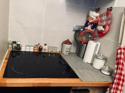 a kitchen with a counter top with a chef figurine on it at Chez moi in Chamonix-Mont-Blanc