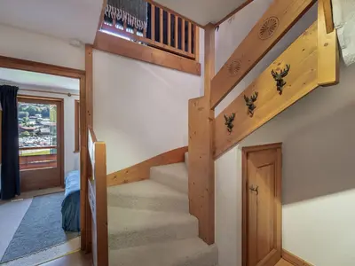 a staircase in a house with wooden steps at Appartement 3 ch. à Megève proche centre - FR-1-569-125 in Megève