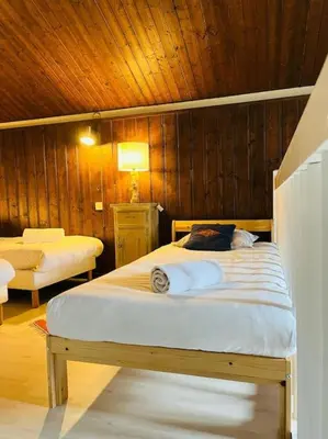 a bedroom with a bed with a wooden ceiling at Duplex Le géant 7 voyageurs in Chamonix-Mont-Blanc